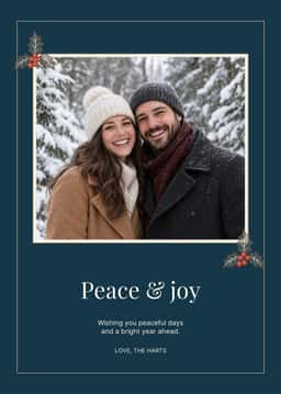 Portrait holiday card with a couple photo, evergreen corner accents, and the message Peace & joy.