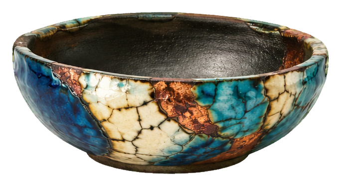 Wide raku pottery bowl with blue, tan, and dark crackled glaze