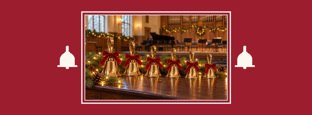Christmas bells with red ribbons on a decorated table in a church interior.