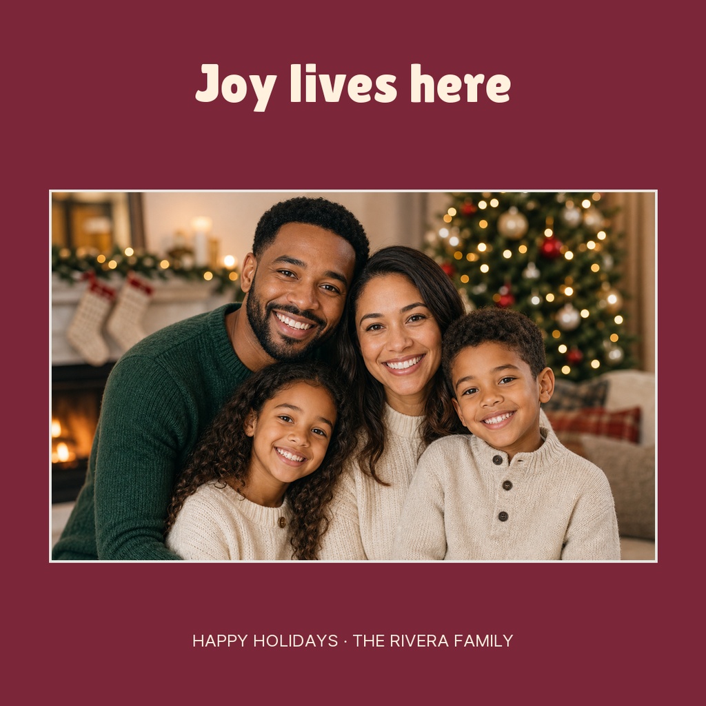 Family portrait with Joy lives here headline and holiday greeting on a burgundy square card.
