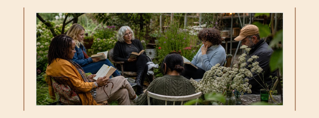 Group of people sitting in a garden holding books for a neighborhood book swap